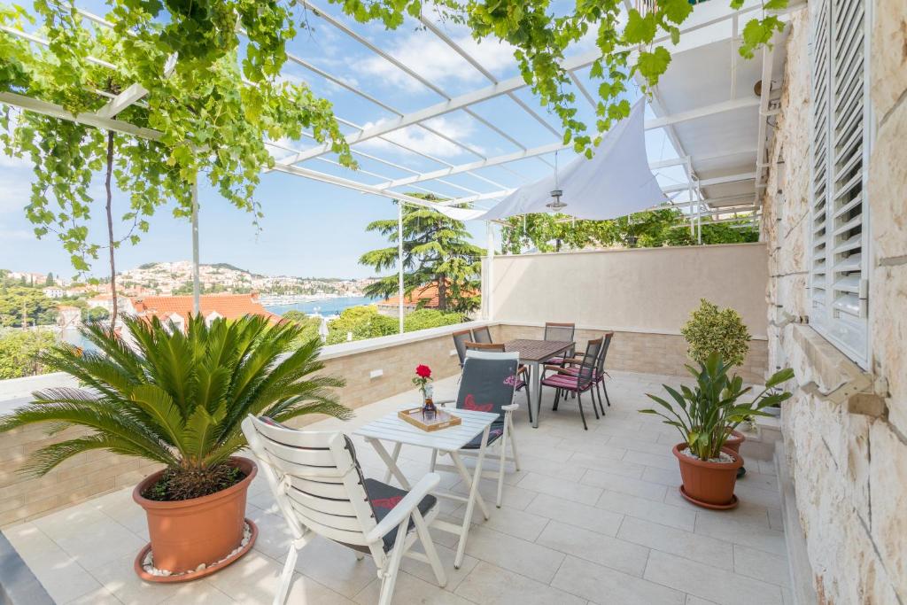 a patio with a table and chairs and plants at Guesthouse Tonko in Dubrovnik