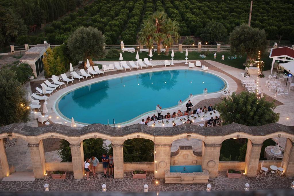 vista sulla piscina con sedie a sdraio di Masseria Savoia a Ginosa Marina