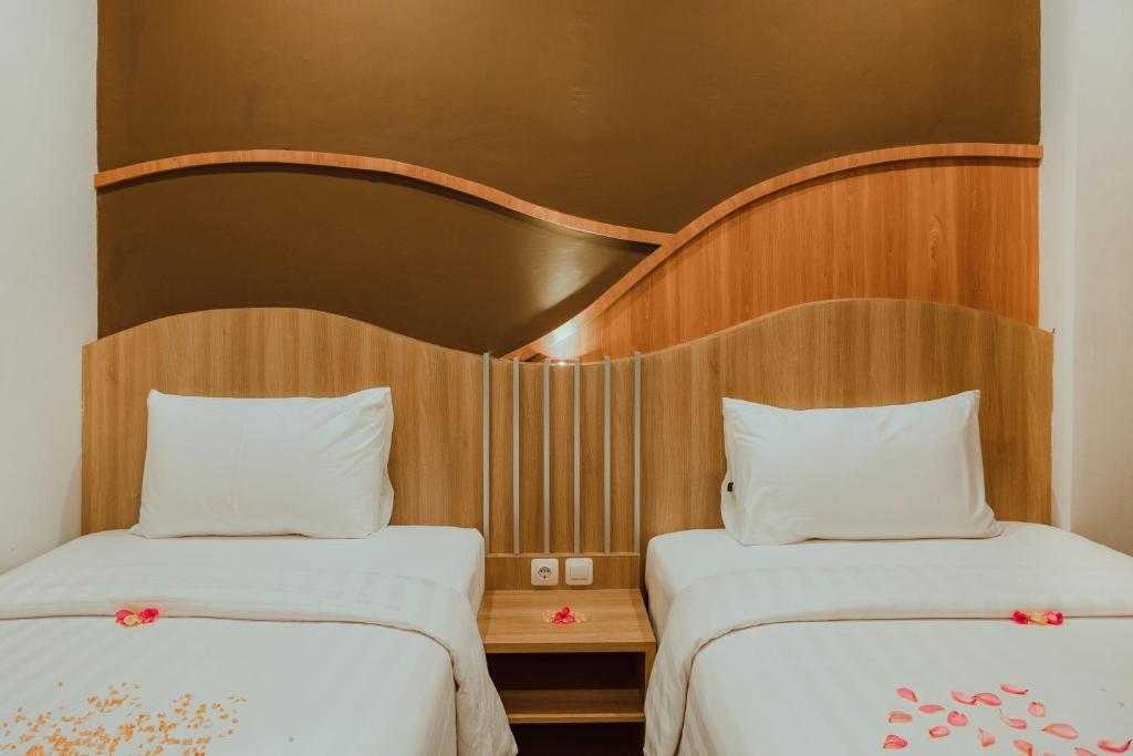 Postel nebo postele na pokoji v ubytování panfila hotel