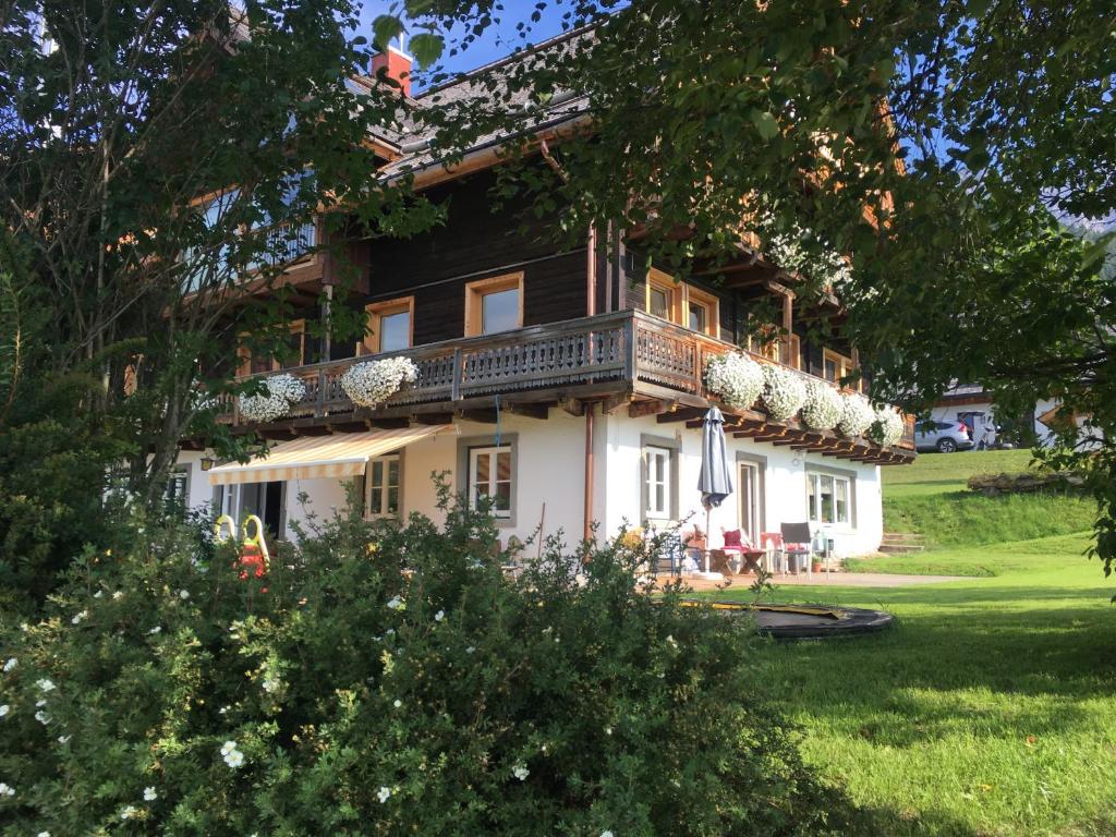 a large house with a balcony on top of it at Schweigerhof in Ramsau am Dachstein