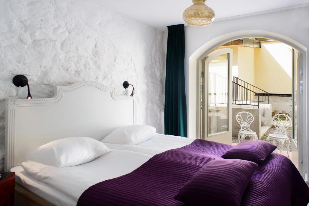 Postel nebo postele na pokoji v ubytování Hotel Hellstens Malmgård
