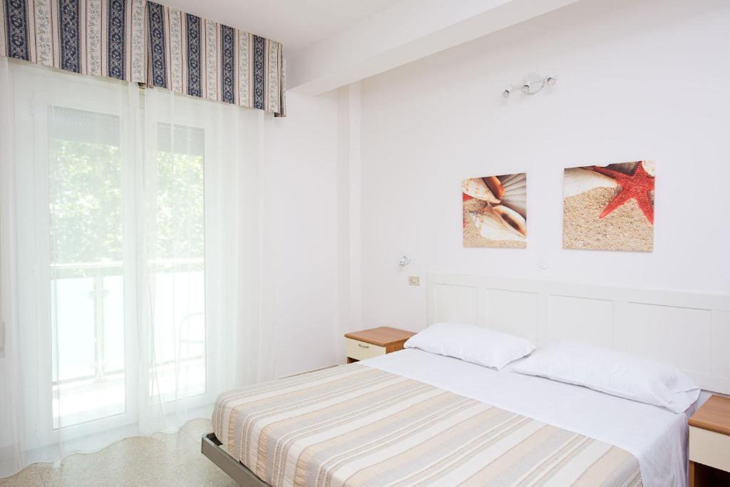 Postel nebo postele na pokoji v ubytování Hotel Helios