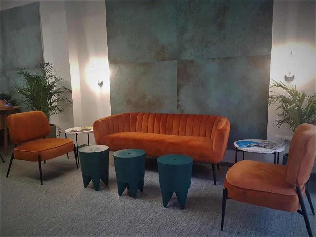 a living room with a couch and two chairs and tables at MD Modern Hotel - Jardines in Valencia