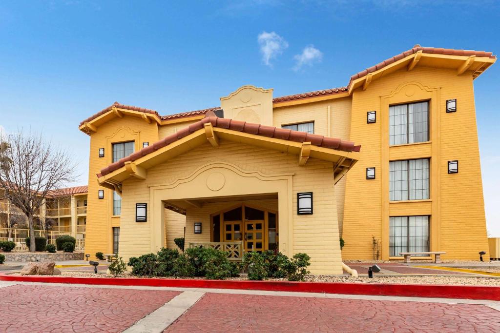 a large yellow building with a red road in front of it at La Quinta Inn by Wyndham El Paso West in El Paso