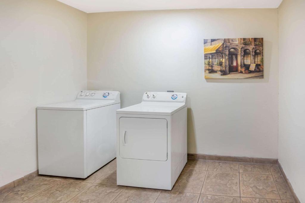 two white washing machines in a room with a painting at Holiday Inn Express & Suites - Ardmore by IHG in Ardmore