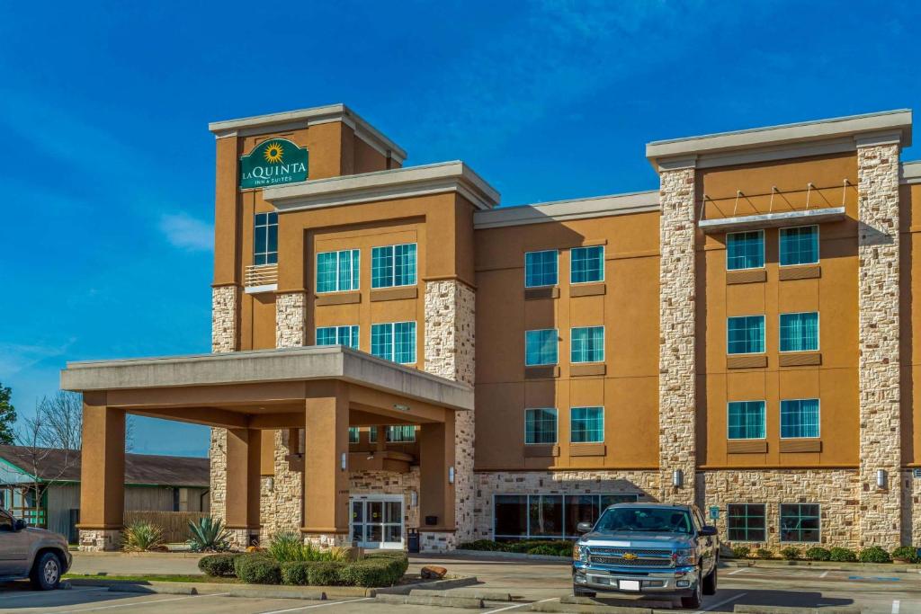 a building with a car parked in front of it at La Quinta by Wyndham Houston Humble Atascocita in Humble