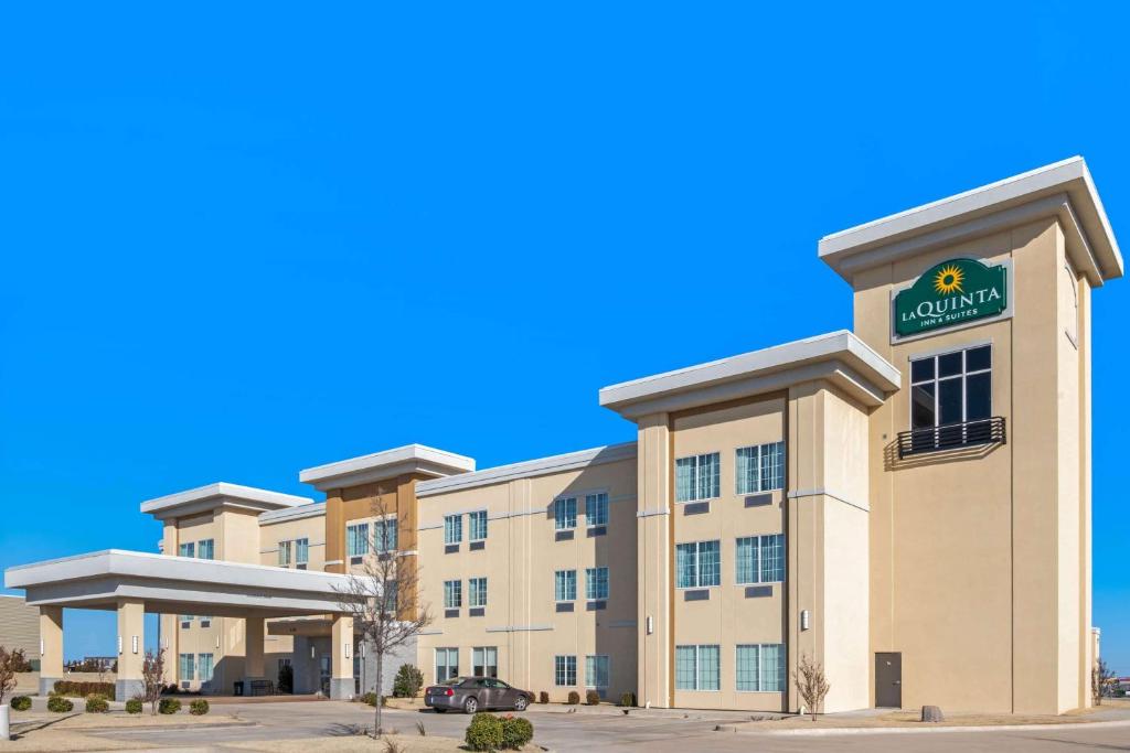 a rendering of a hotel with a sign on it at La Quinta by Wyndham Weatherford OK in Weatherford