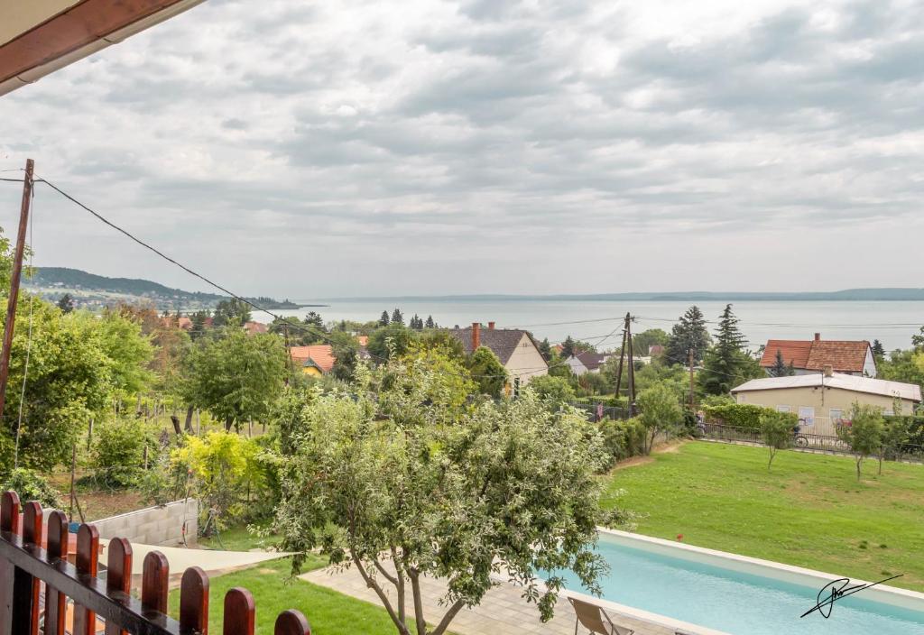 a view from the balcony of a house with a swimming pool at OMEGA in Badacsonytomaj