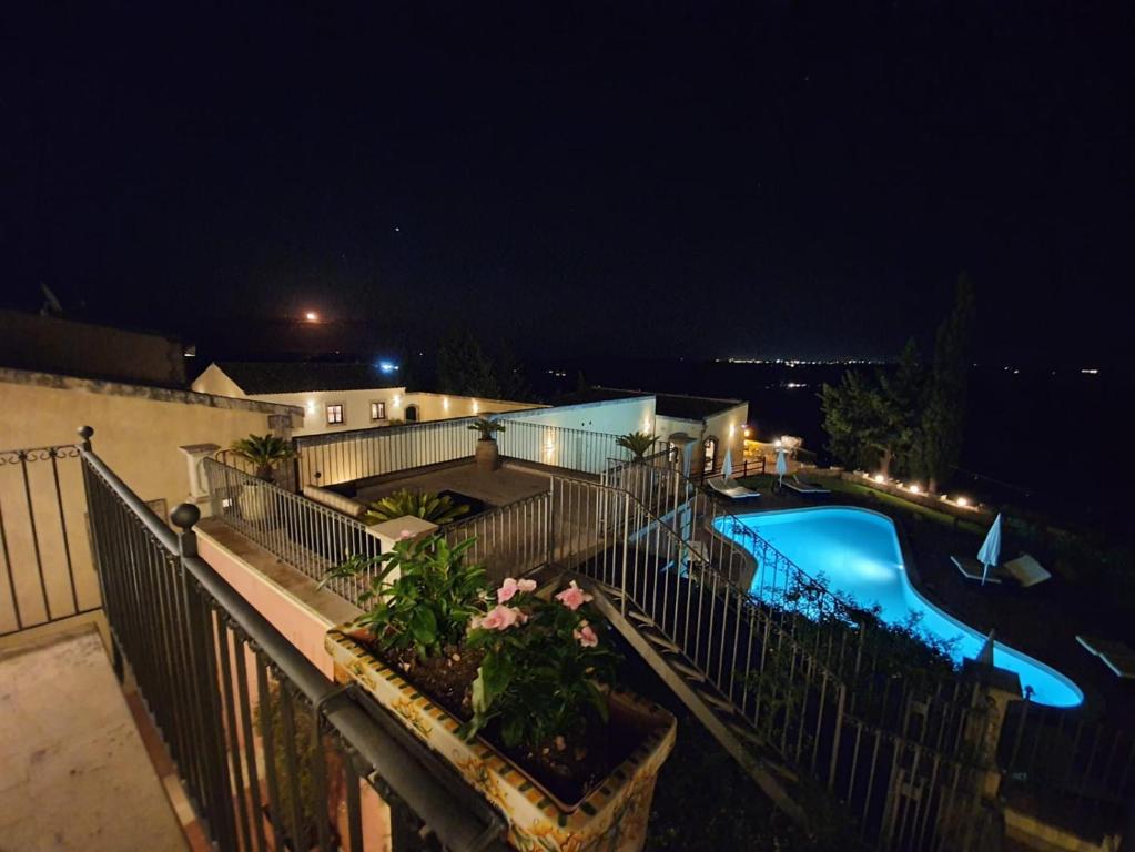 a view of a swimming pool at night at Hotel La Corte Del Sole in Noto