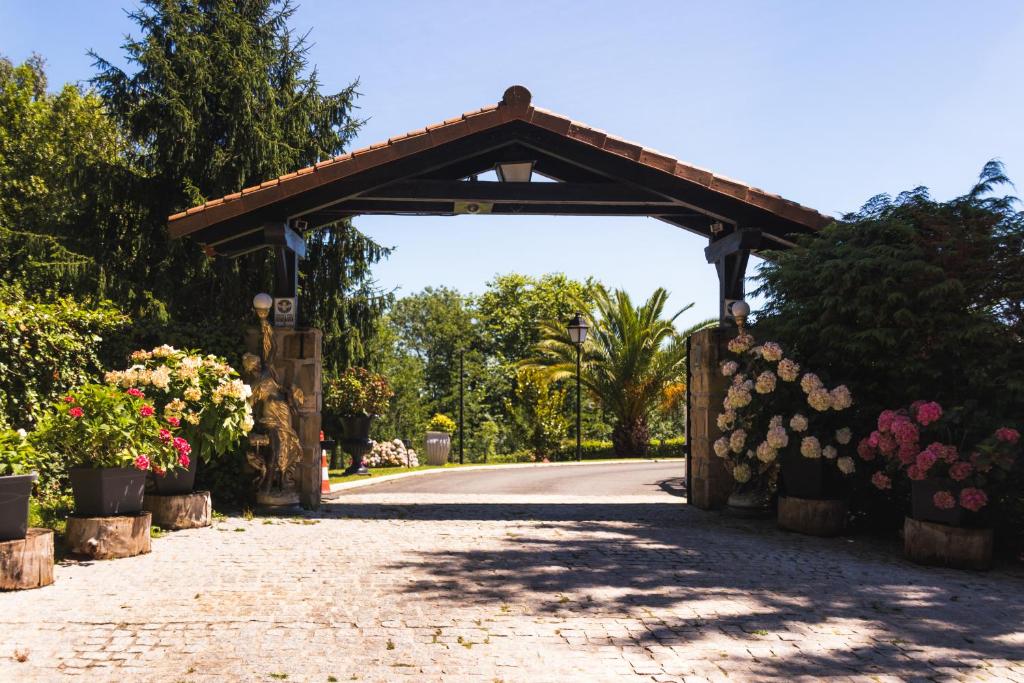 an entrance to a garden with flowers in pots at Villa Higer in Hondarribia