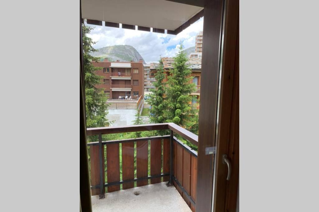 a door leading to a balcony with a view at STUDIO CHALETS DE SOLAISE in Val dʼIsère