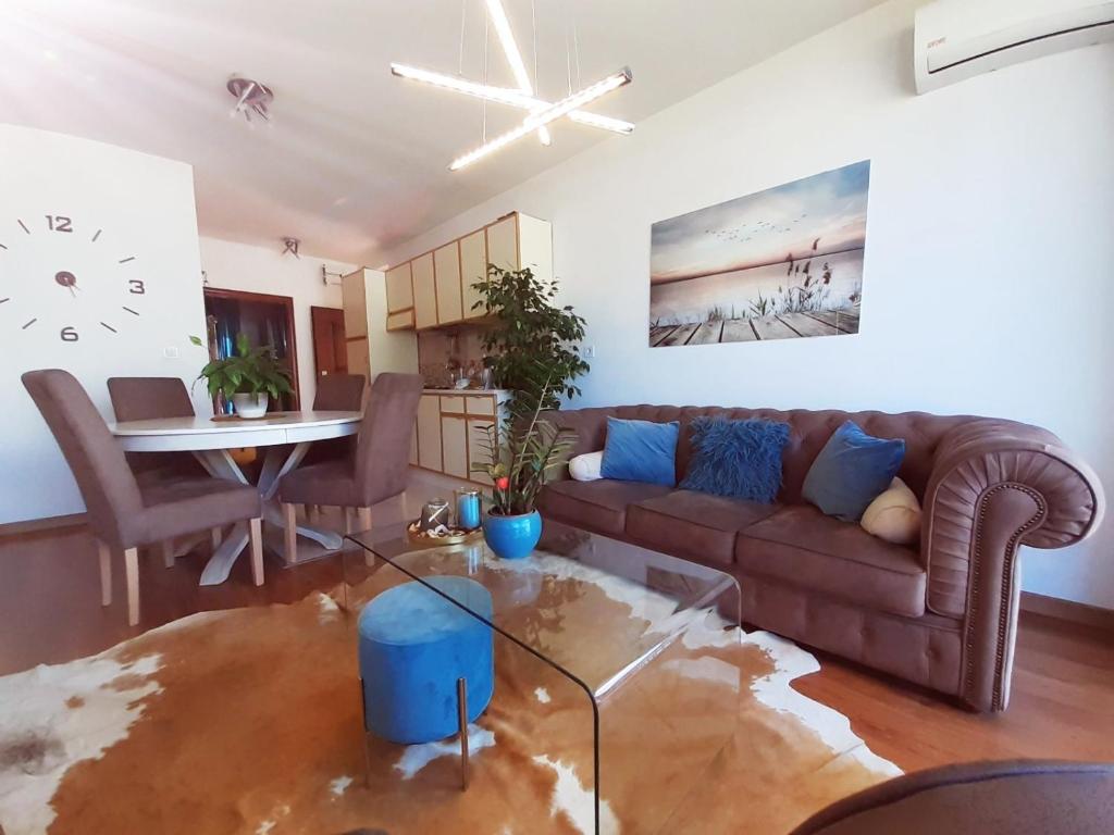 a living room with a couch and a table at Apartmani Sport Igalo in Herceg-Novi