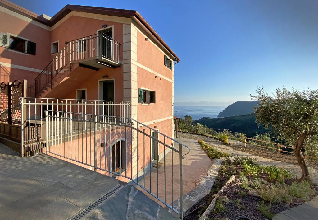 a building with a staircase and a balcony on it at Agriturismo Missanega in Monterosso al Mare