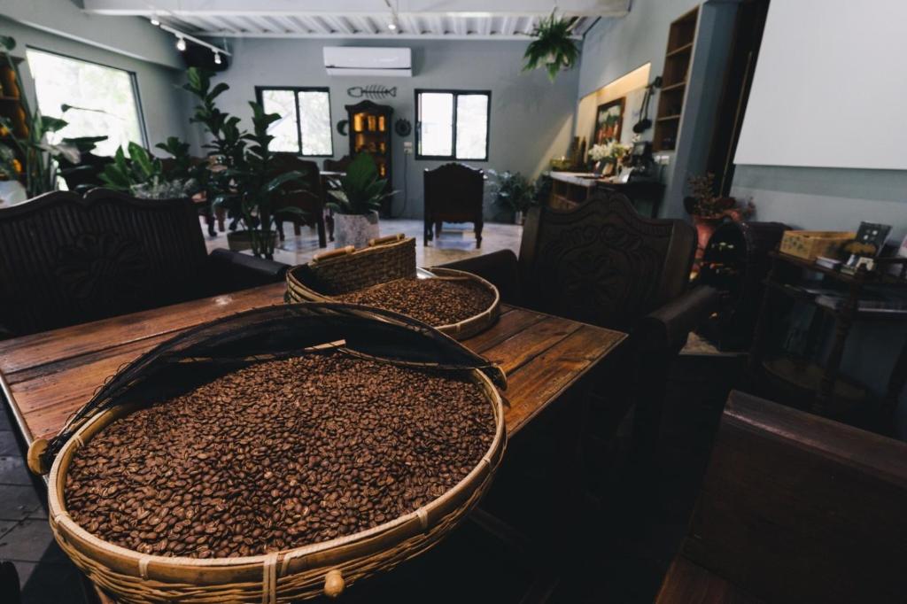 two baskets of coffee beans on a wooden table at Monet Garden Coffee Farm in Chinan