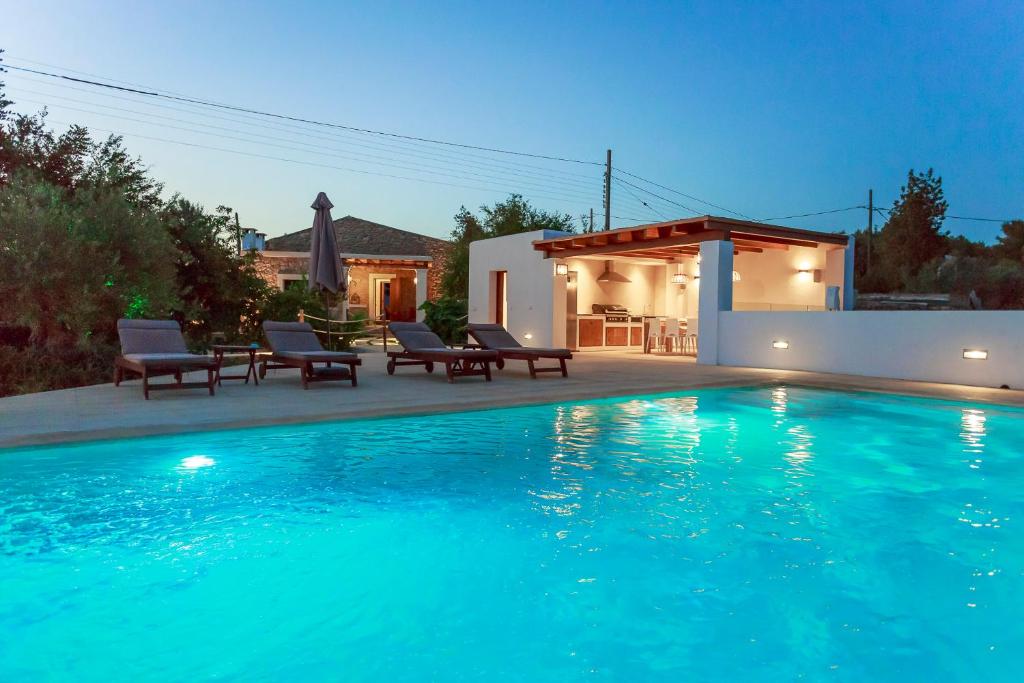 a swimming pool in front of a house at Hort den Pilot in Sant Rafael de Sa Creu