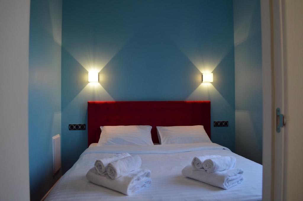 a bedroom with a bed with two towels on it at Arena,VIP in Kyiv