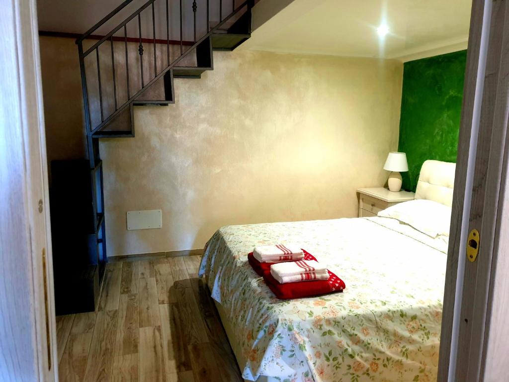 a bedroom with a bed and a staircase at Apartment Mary in Terracina
