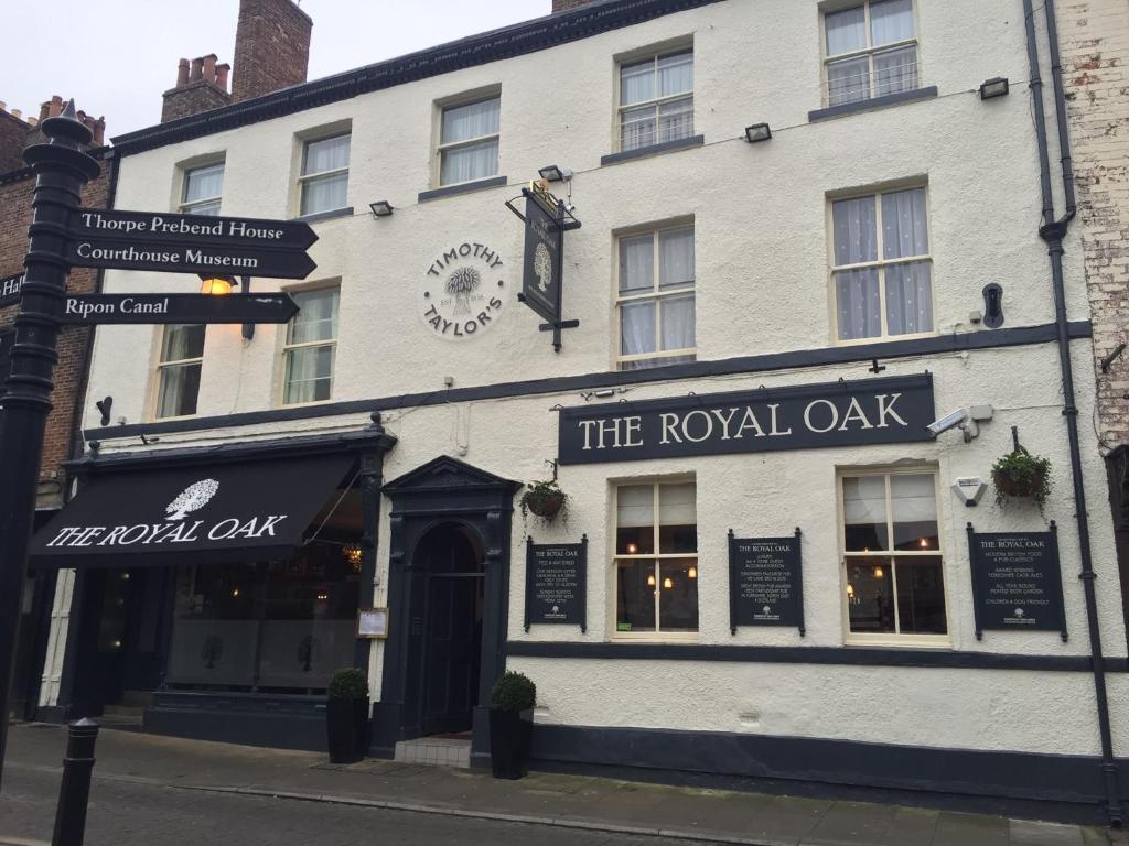 a white building with a royal oak sign on a street at The Royal Oak Ripon in Ripon