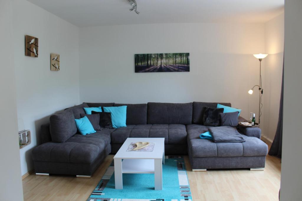 a living room with a couch and a table at Ferienwohnung Ruheoase in Bad Harzburg