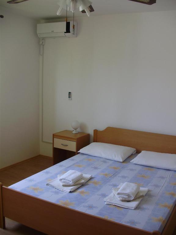 a bedroom with a bed with two towels on it at Villa Welcome in Vrboska
