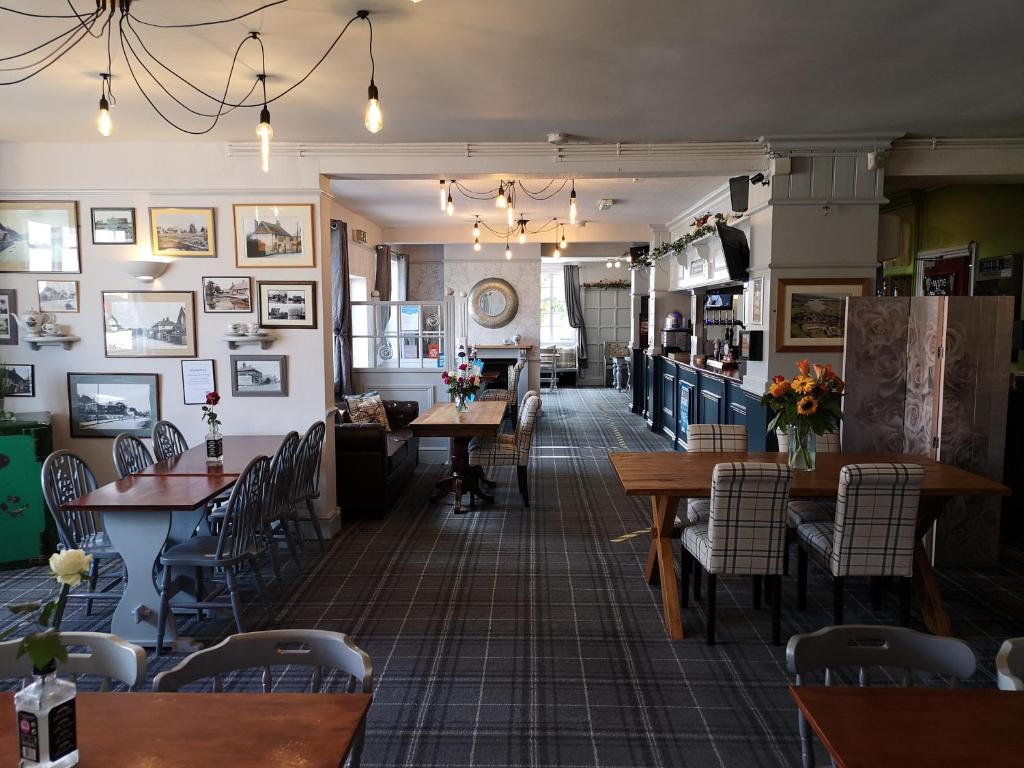 a restaurant with tables and chairs in a room at Woolpack Inn in Chichester