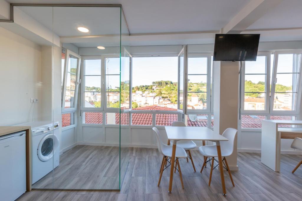 a living room with a table and a dining room at MIRADOR DE LA MURALLA in Betanzos