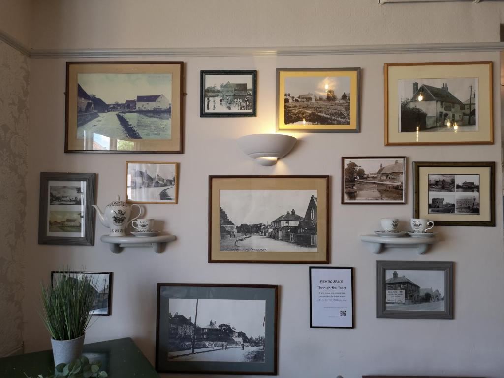 a wall filled with pictures on a wall at Woolpack Inn in Chichester