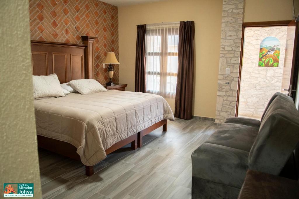Postel nebo postele na pokoji v ubytování Mirador Johya Hotel