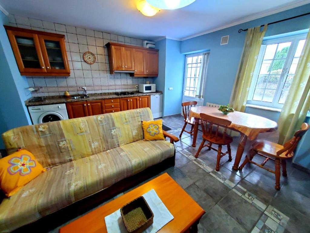 a living room with a couch and a table at Apartamentos Turísticos Rosa in Ribadeo