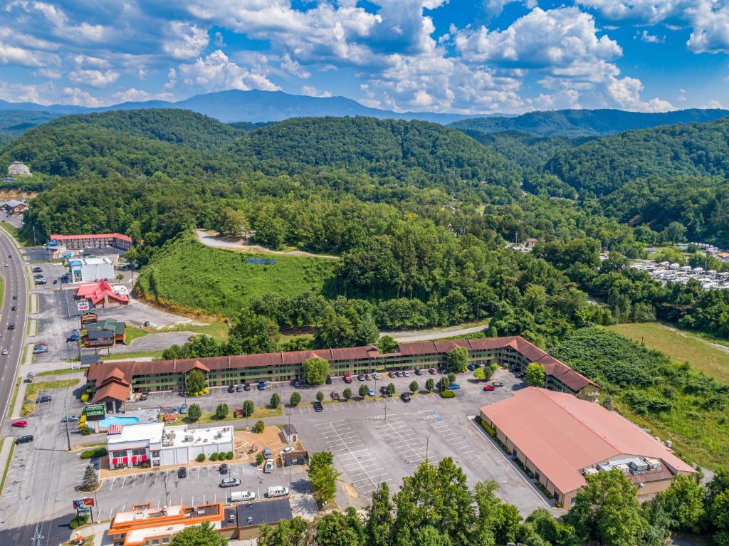 an aerial view of a building with mountains in the background at Days Inn By Wyndham Pigeon Forge South in Pigeon Forge