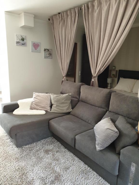 a gray couch in a living room with pillows at Marina Plaza in Vilamoura
