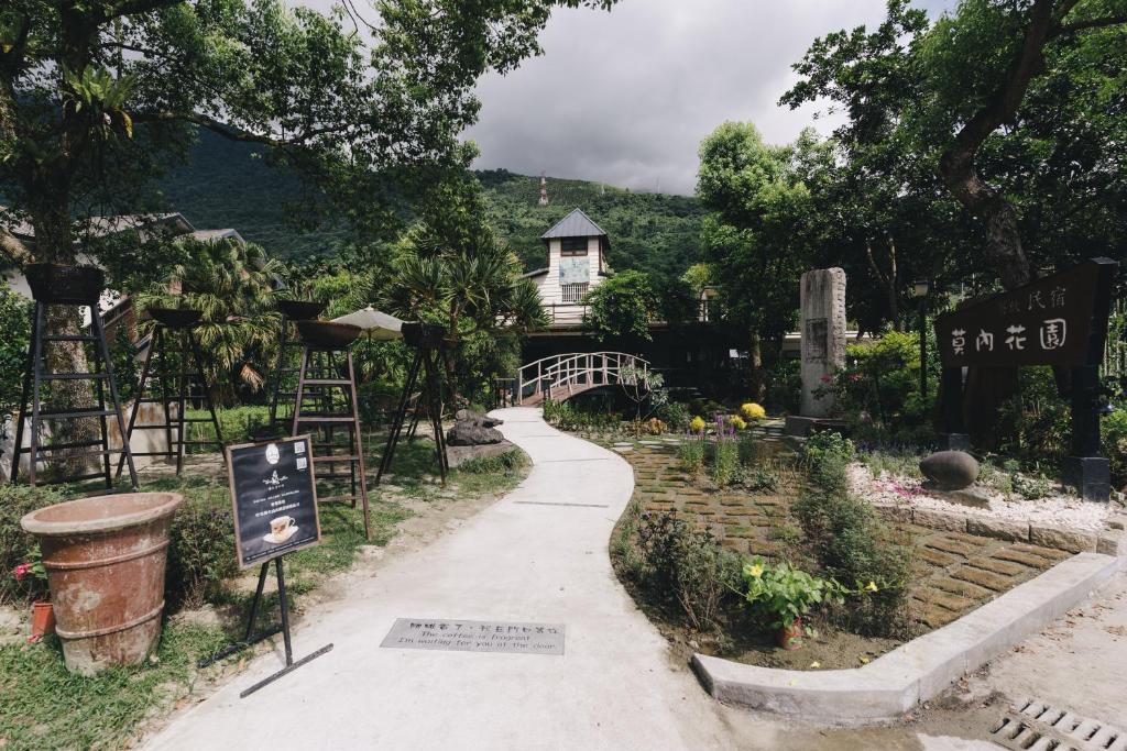 池南村的住宿－莫內花園民宿，花园内一条小径,房子的背景