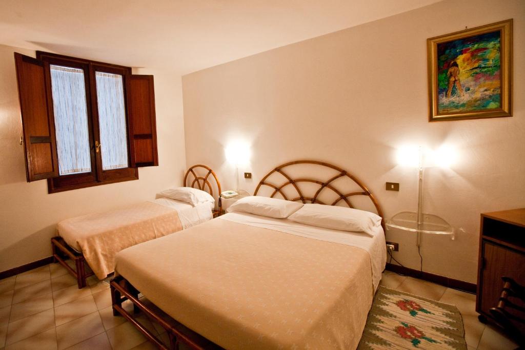 Posteľ alebo postele v izbe v ubytovaní Hotel Moderno