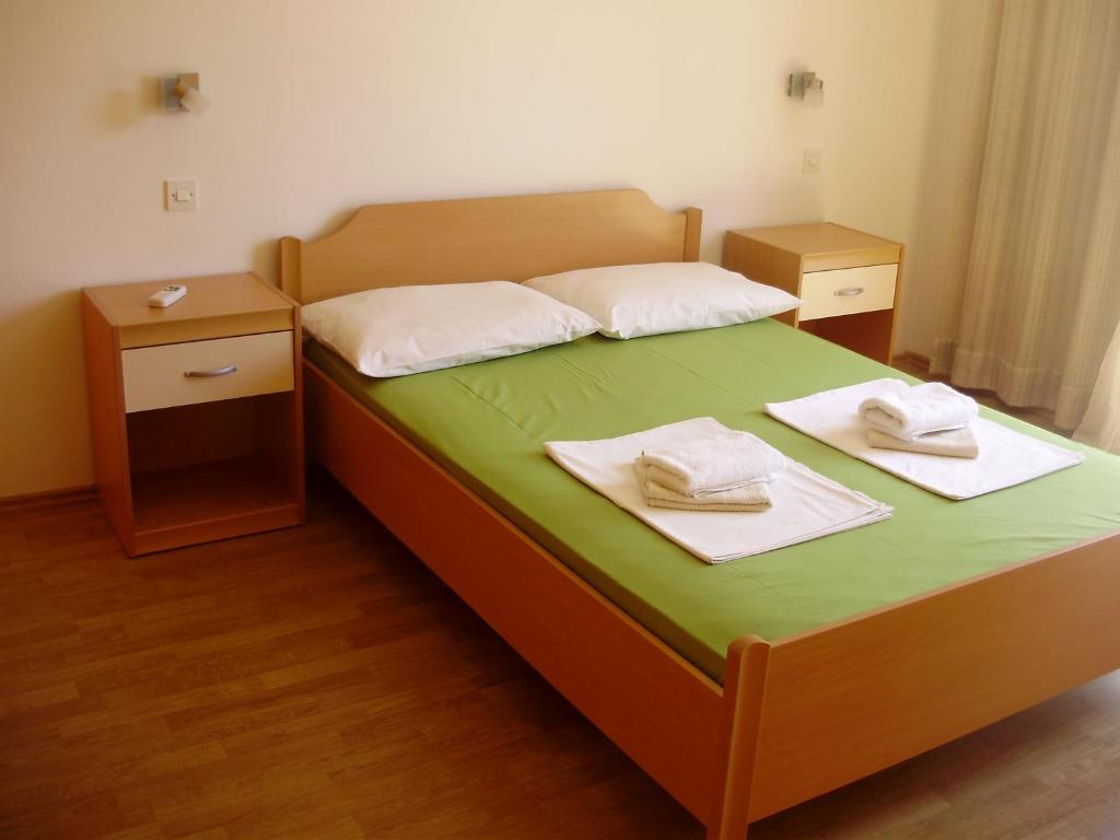 a bedroom with a bed with two towels on it at Villa Welcome in Vrboska