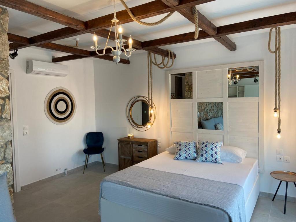 a bedroom with a bed and a mirror and a chair at Oliva in Faliraki