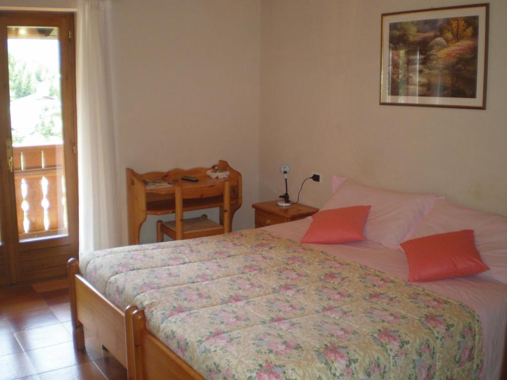 Postel nebo postele na pokoji v ubytování Hotel Residence La Rosa