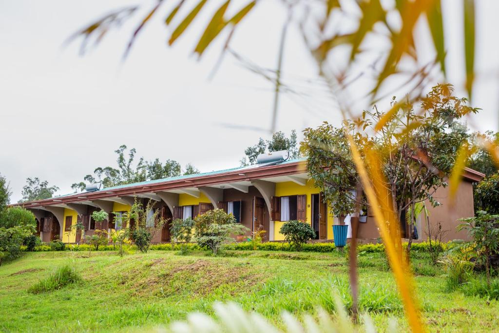 a house in the middle of a yard at Andasibe Lemurs Lodge in Andasibe