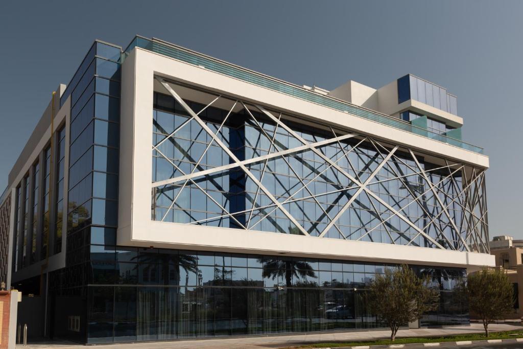 an office building with a large glass facade at Beach Walk Hotel Jumeirah in Dubai