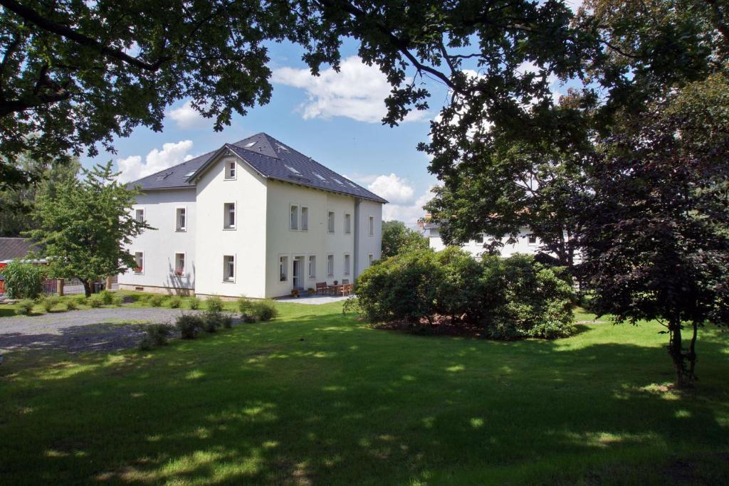 a large white house with a large yard at Apartmány Krásná Lípa in Krásná Lípa