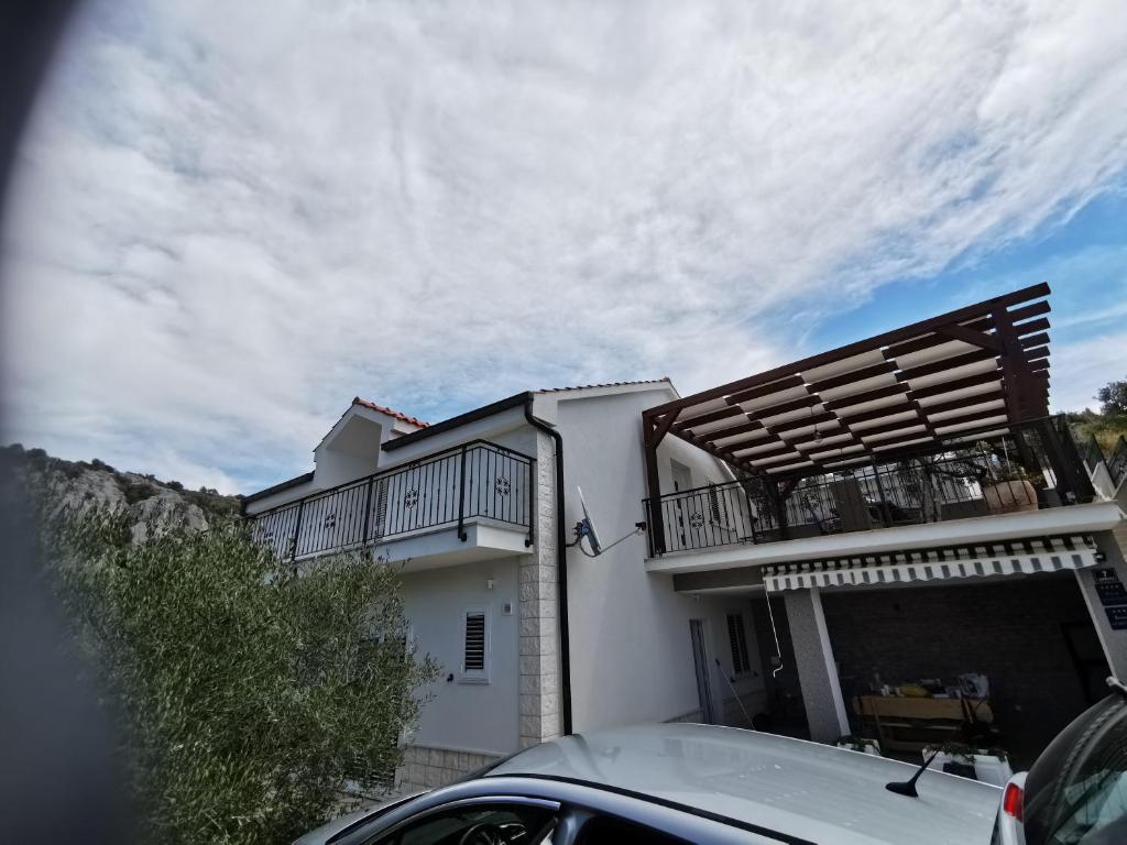 a white house with a balcony on top of it at Villa Ivanka in Sevid