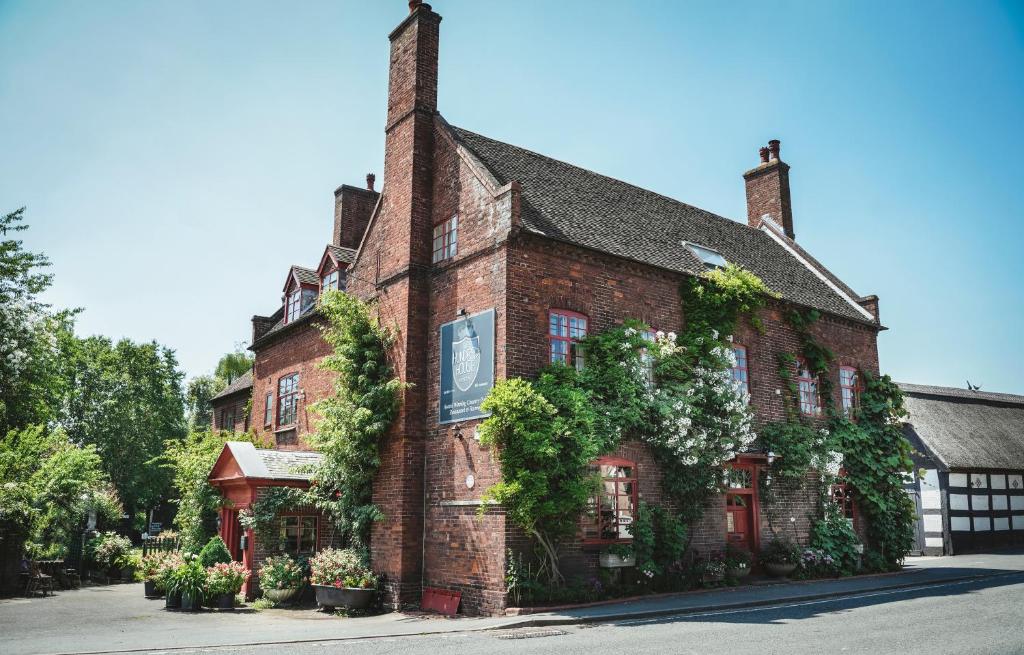 an old brick building with ivy growing on it at Hundred House Hotel in Ironbridge