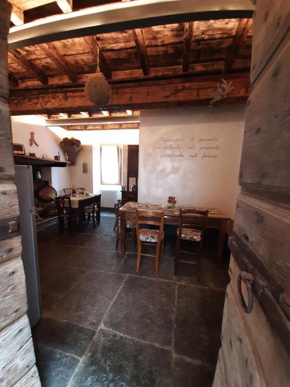 a dining room with a table and chairs and a whiteboard at Antica Calvasino in Lezzeno