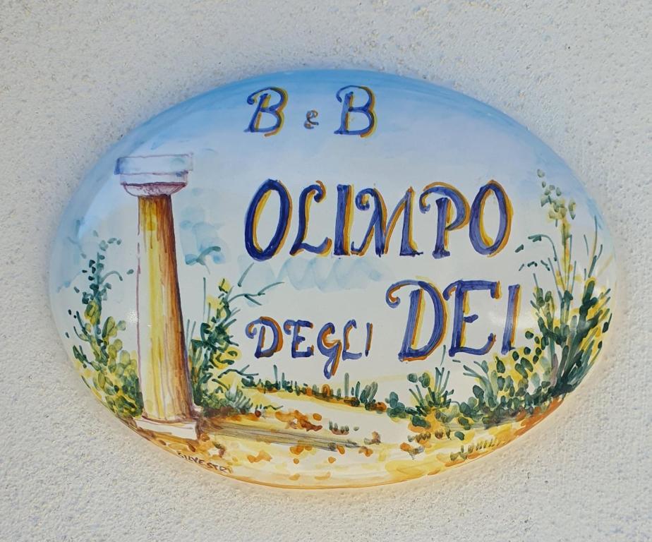 a sign on a wall that reads obimpo deep debt at Olimpo degli Dei in Agerola