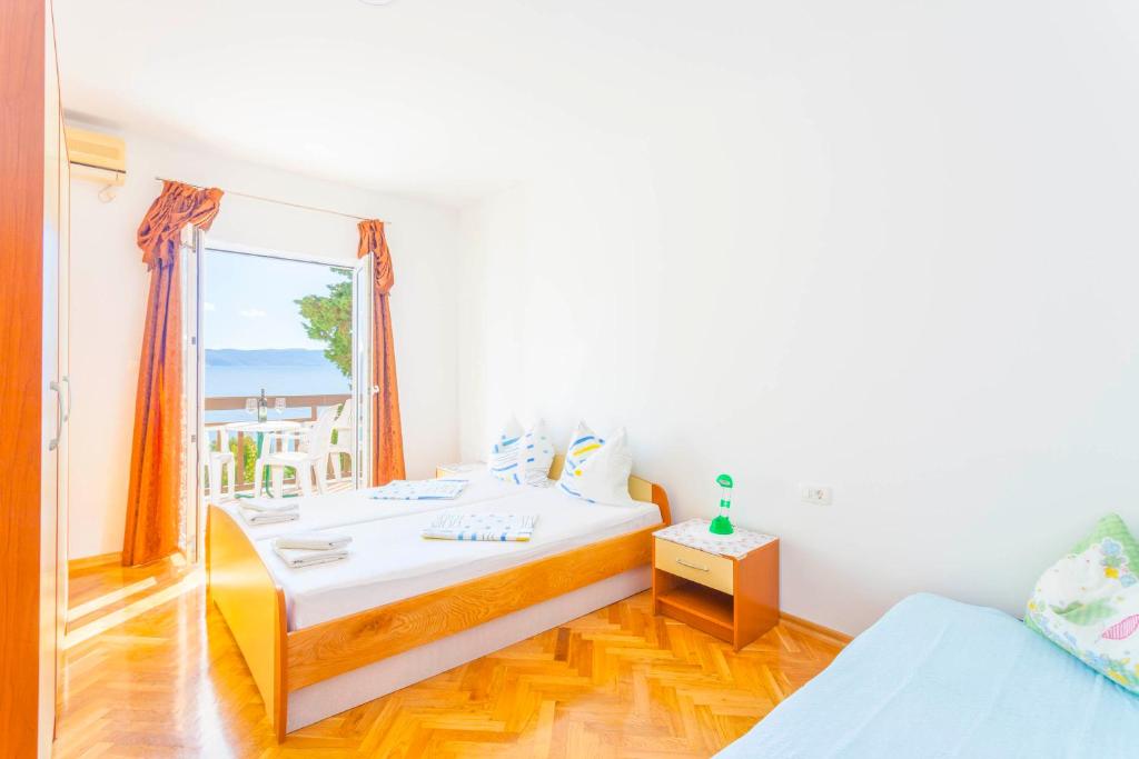 Posteľ alebo postele v izbe v ubytovaní APARTMANI GRBAVAC