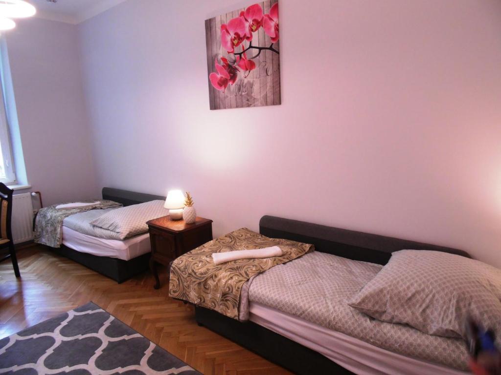Posteľ alebo postele v izbe v ubytovaní Apartament Orchidea