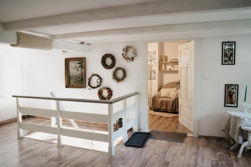 a living room with a table and a bedroom at KOWALÓWKA in Mirsk