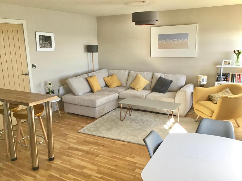 a living room with a couch and a table at North Sea View Apartment in Scarborough
