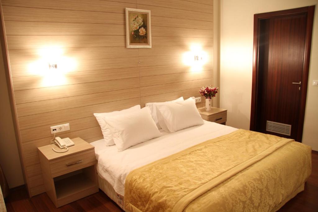 a hotel room with a bed and a telephone at Solis Hotel in Istanbul