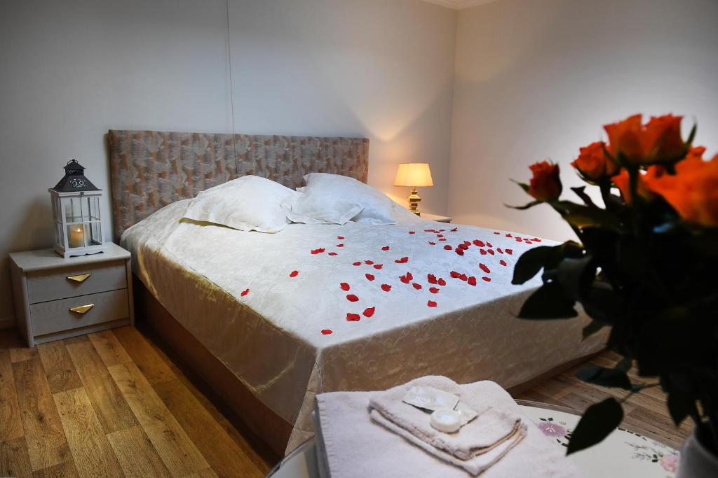 a bedroom with a bed with red petals on it at Motel Koolen in Velp