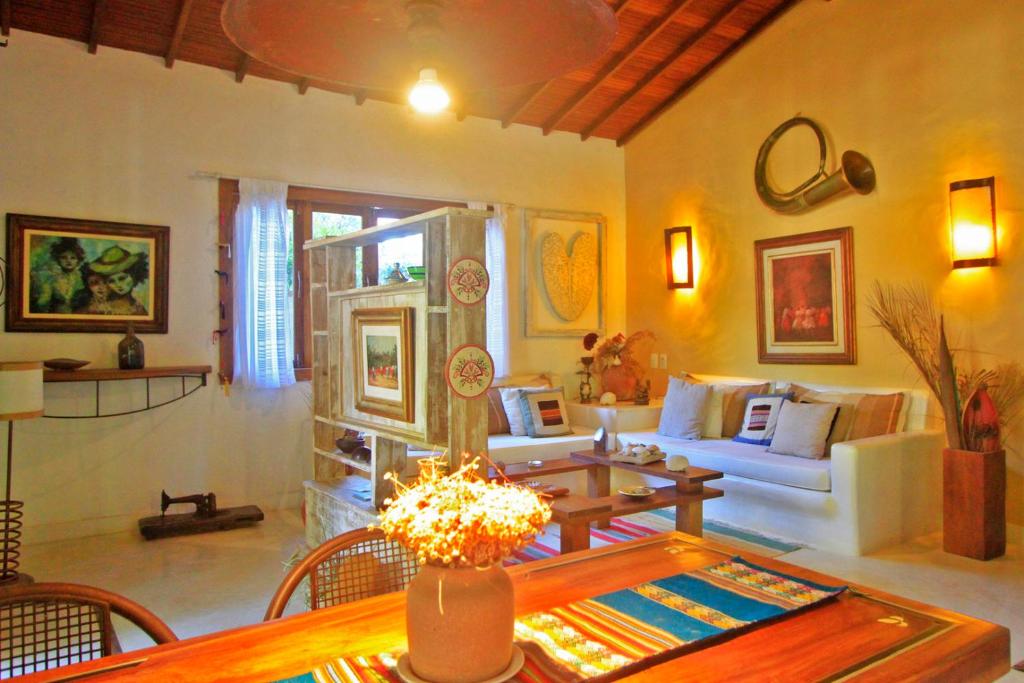 a living room with a couch and a table at Vila Querência - Trancoso in Trancoso